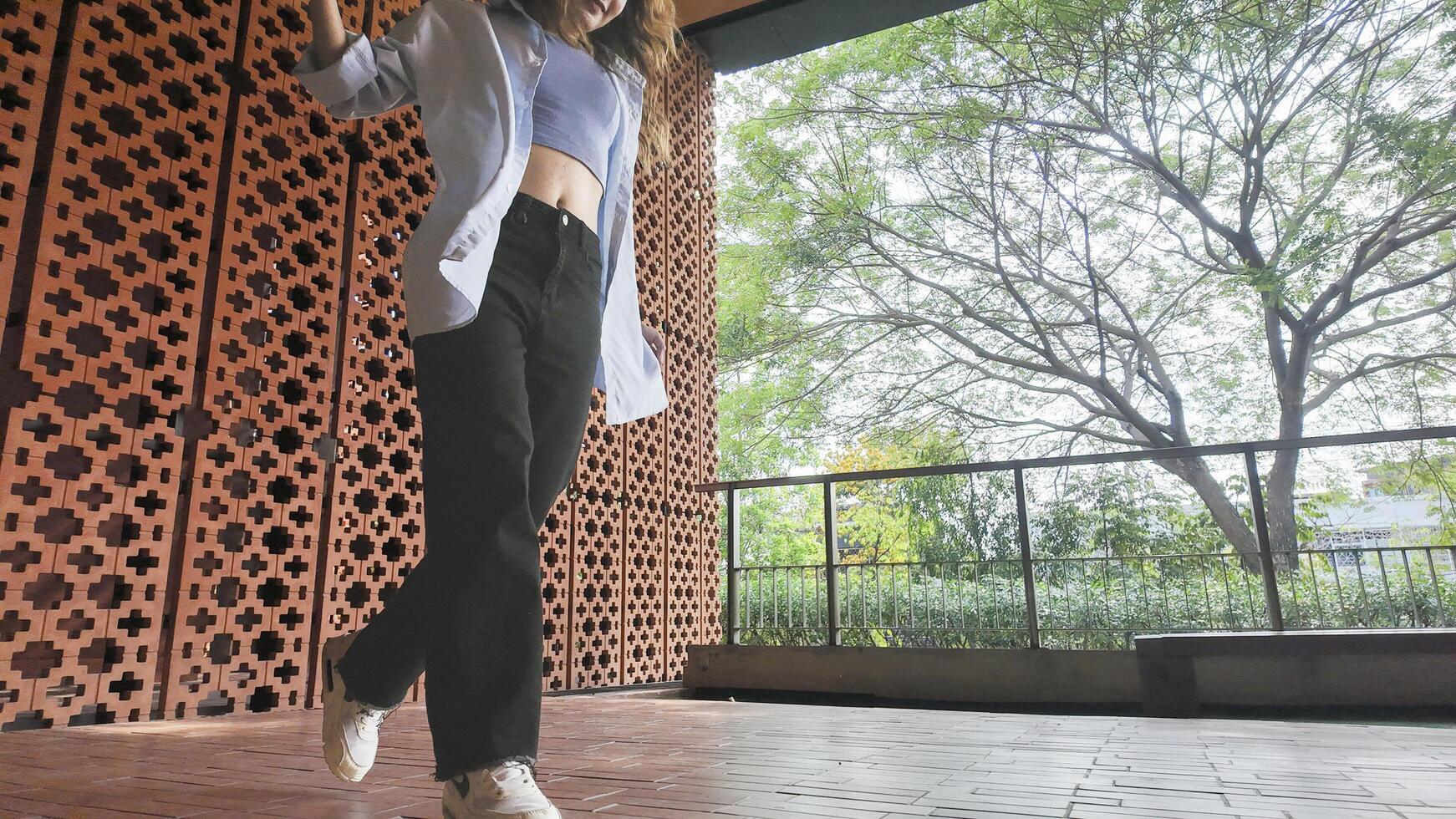 Asian girl dancing hip hop having fun With brightness and cheerfulness in the park area photo