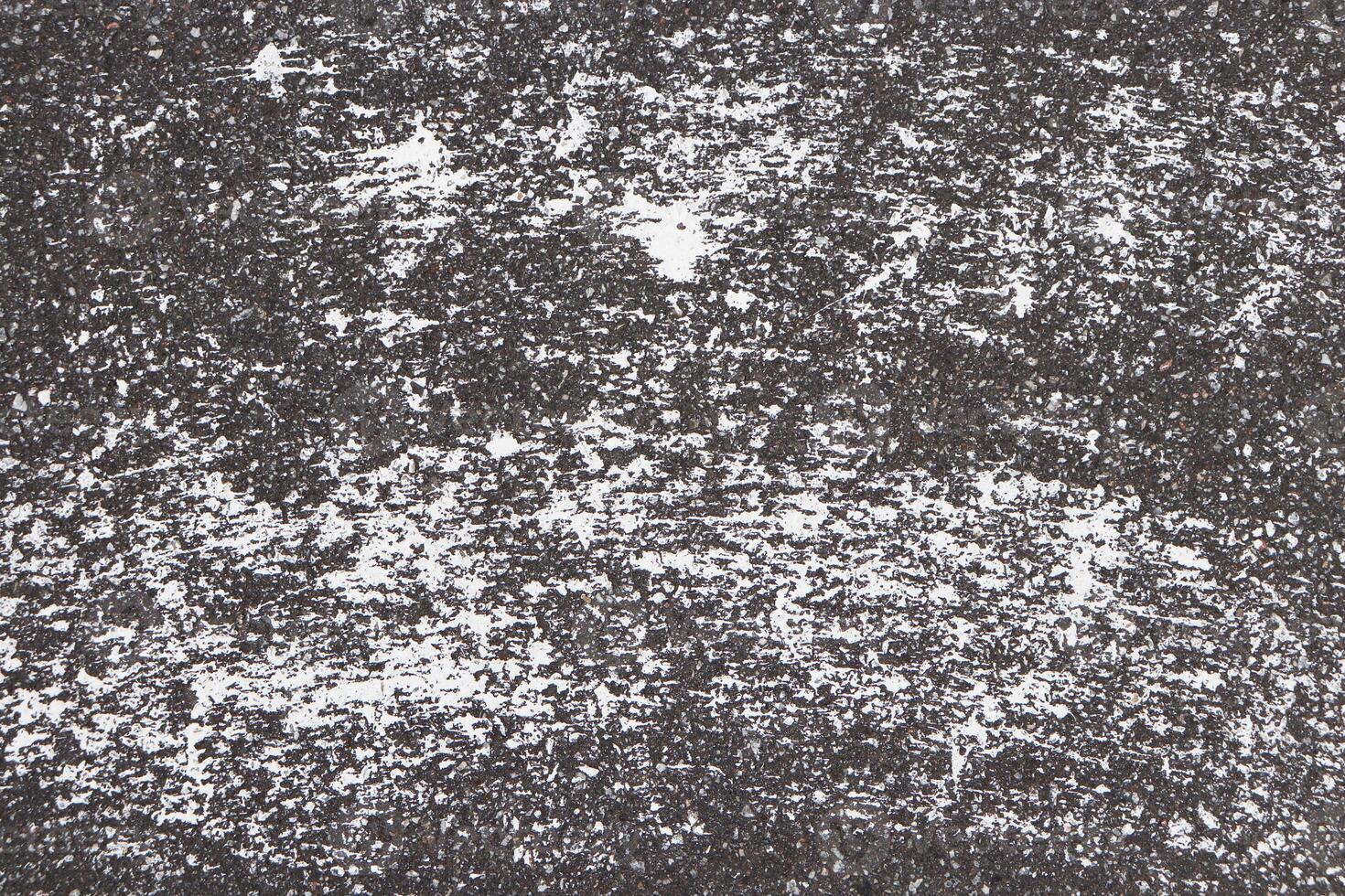 Road asphalt texture. Bitumen structure with white paint. photo