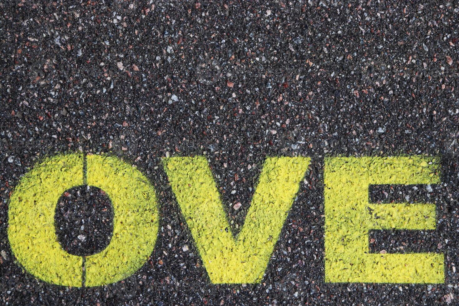 Road asphalt texture. Bitumen structure with painted love word. photo