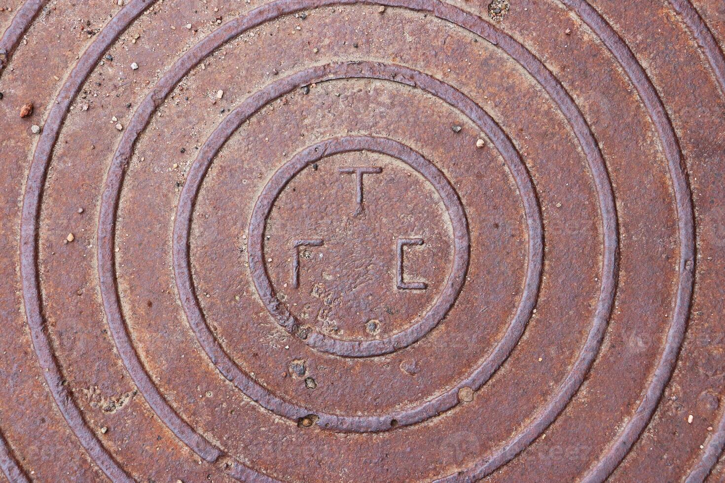 Rusty Road Hatch. Iron Manhole Urban Art. photo