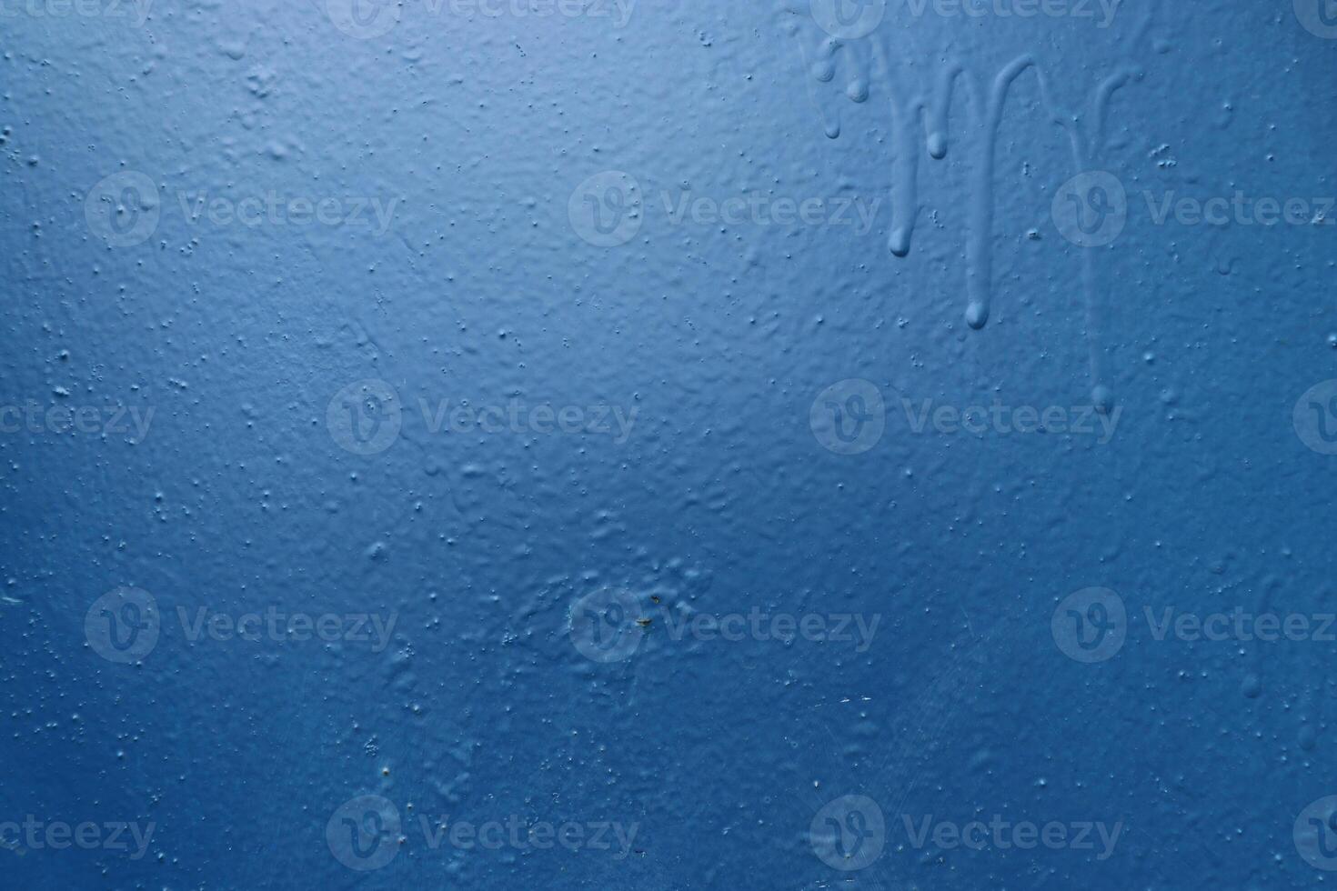 Blue painted wall with paint stains. Urban background texture. photo