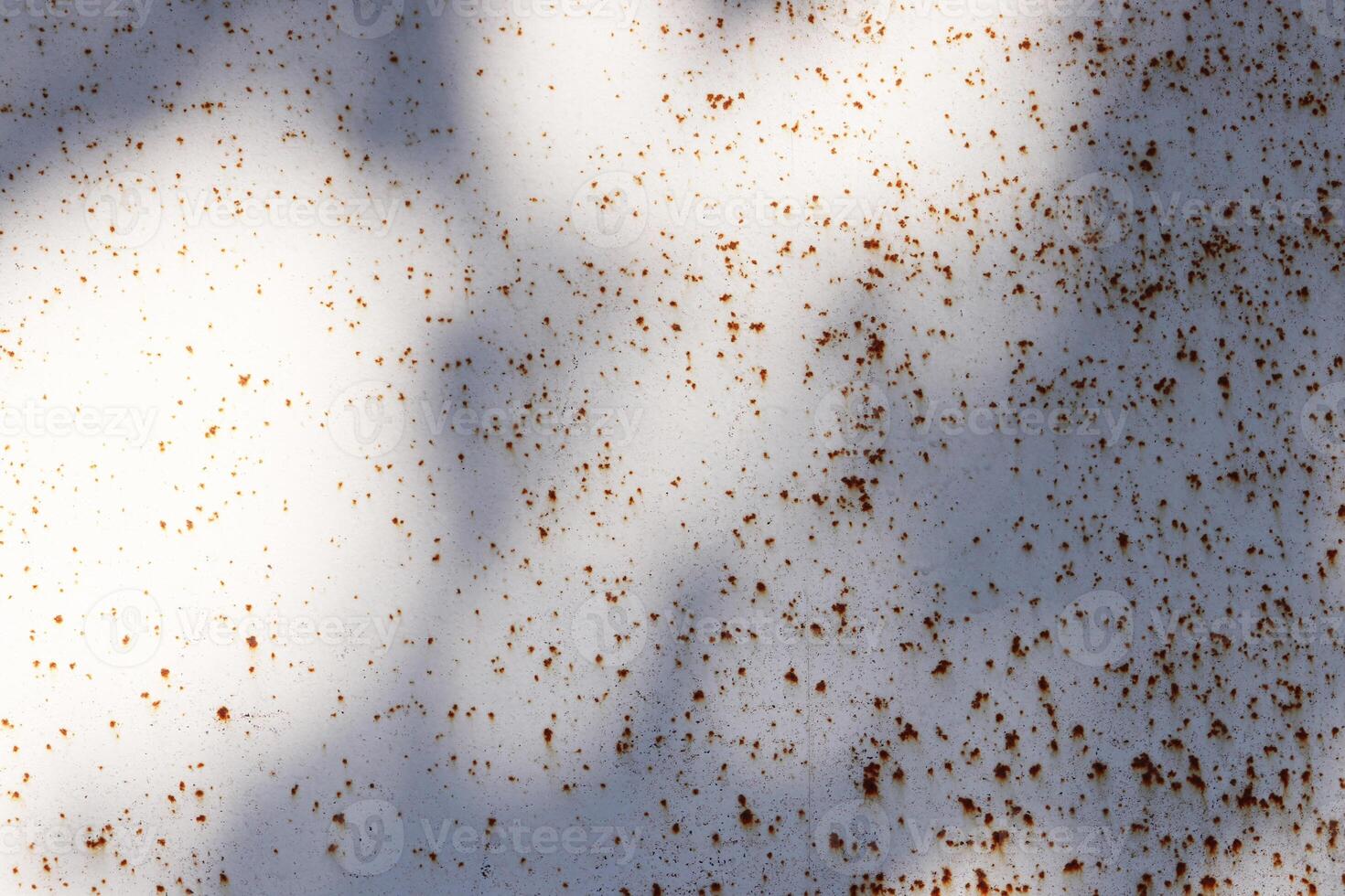 Rusty Paint Wall Texture with Sun Rays. Scratches and Cracks. photo