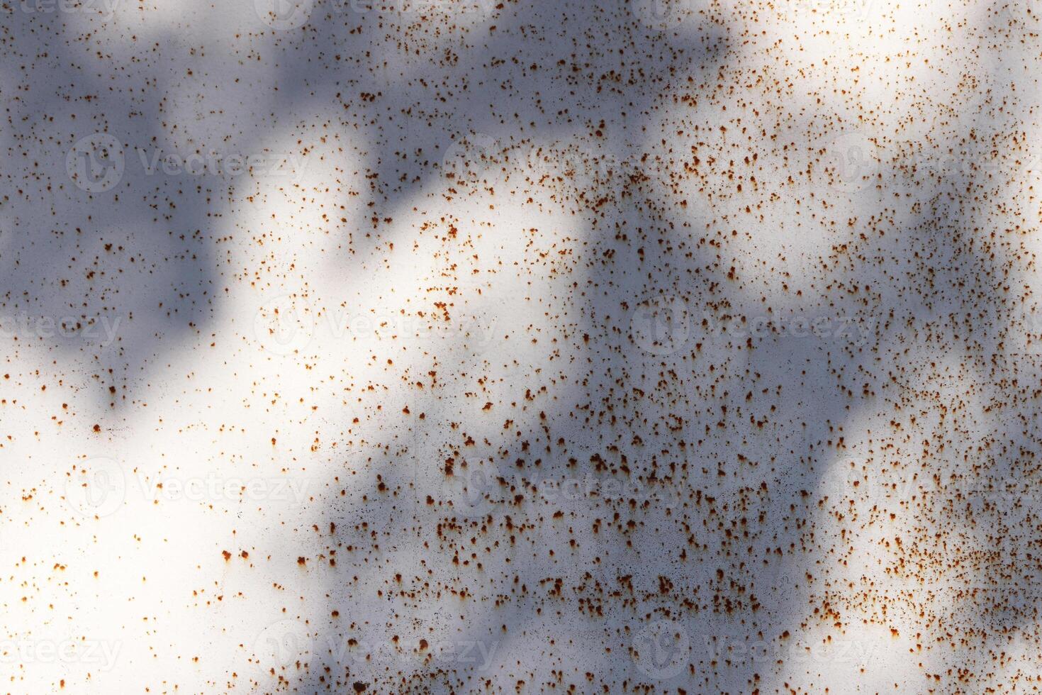 Sun Rays on White Rusty Paint Wall Texture photo