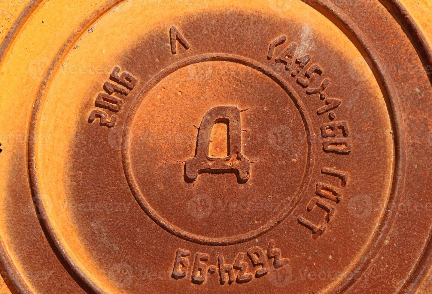 Rustic hutch. Metal cap of road. Iron Manhole Urban Art. photo