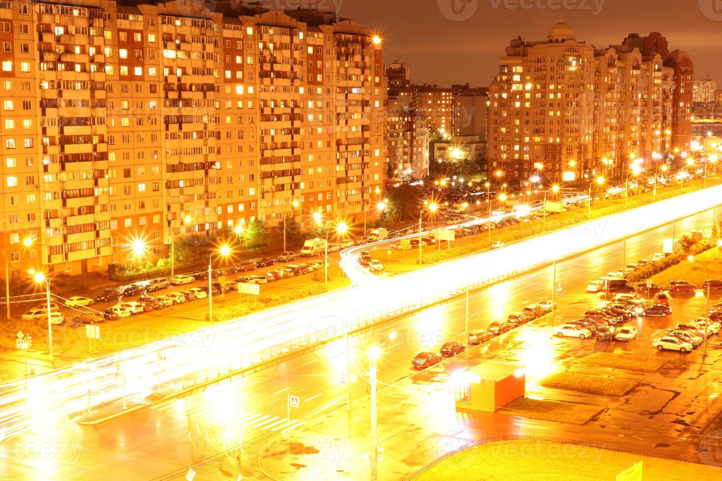 Night intersection road lights exposure landscape. Living buildings on background. Saint-Petersburg, Bogatirskiy avenu. photo