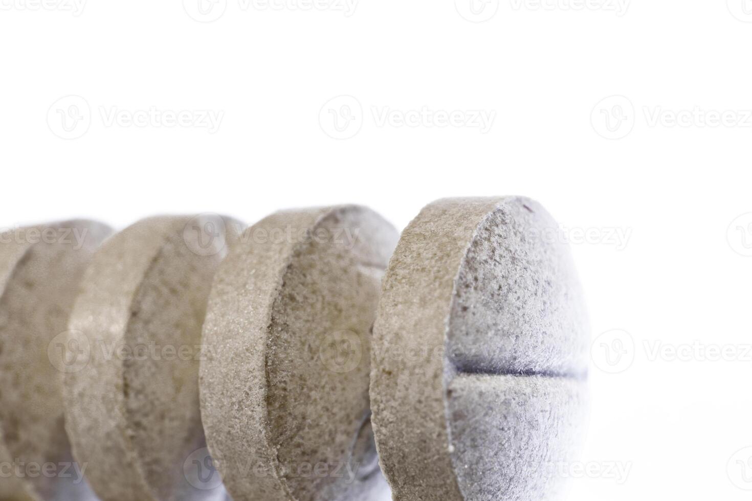 Gray Medicine Tablets Row. Pharmacy Pills on Lighted Background. Macro Closeup. photo