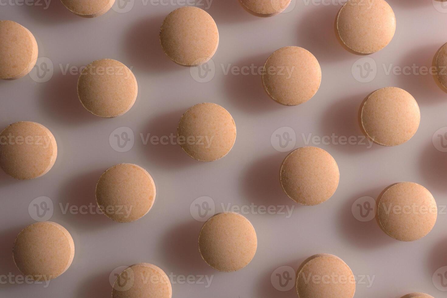 Peach Isolated Pills. Medical Tablets Background. Macro Closeup. photo