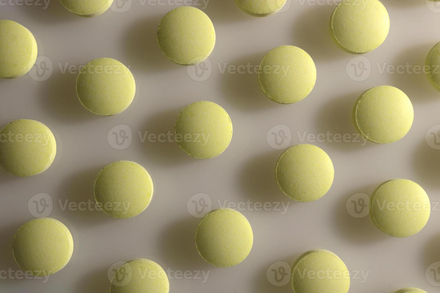 Yellow Isolated Pills Texture. Medical Tablets Background. Macro Closeup. photo