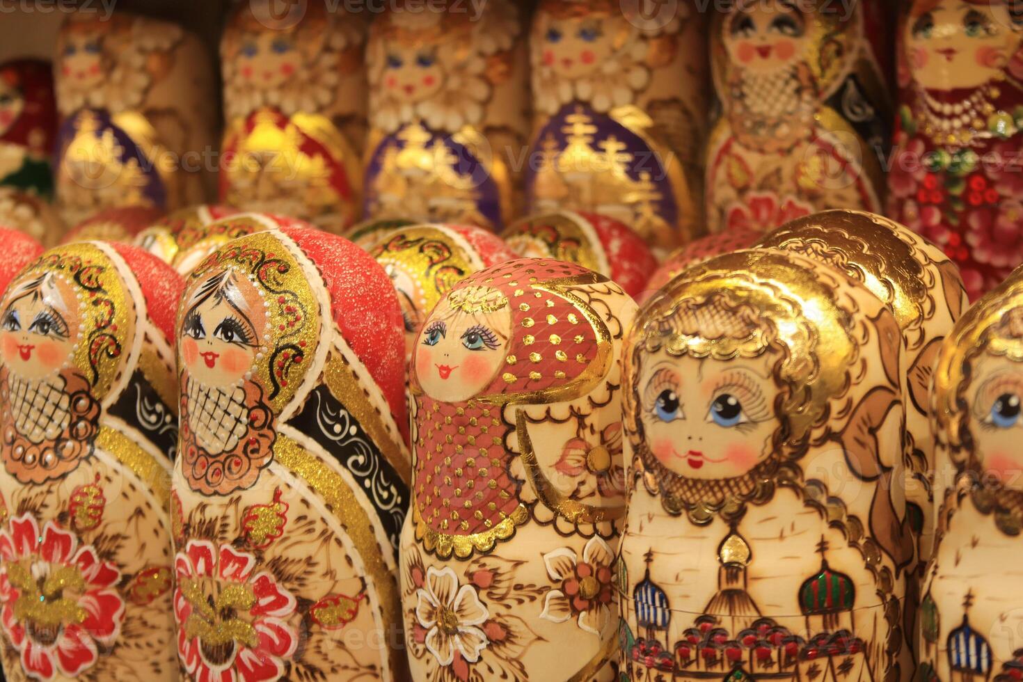 A lot of souvenirs of golden nesting dolls. Many colored golden nesting dolls. photo