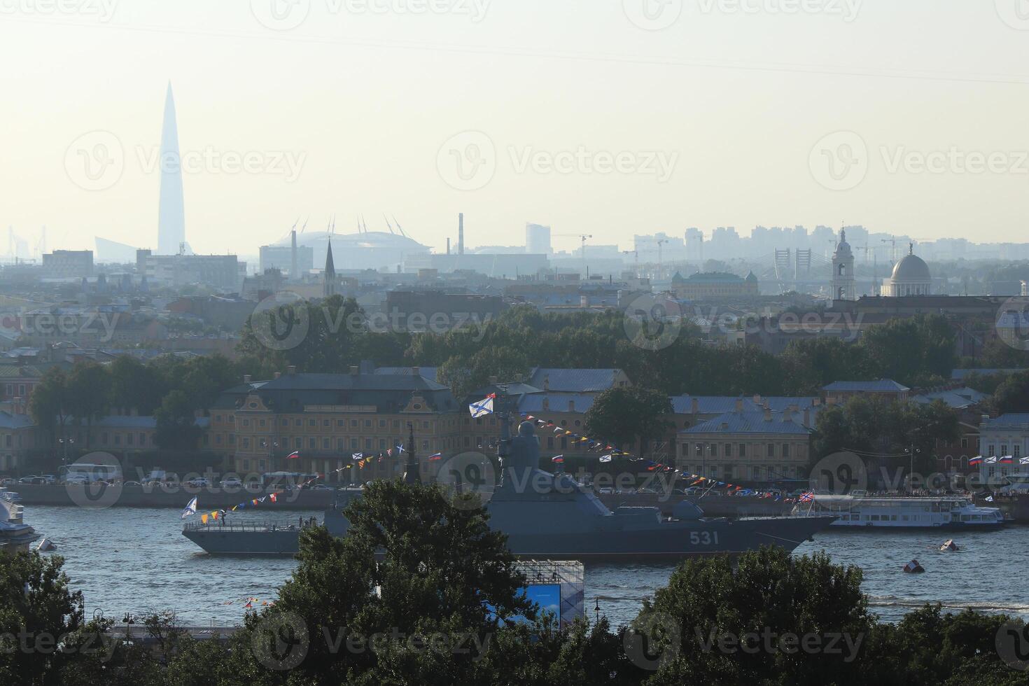 Russian Navy Battleship Soobrazitelniy on Neva River. Saint-Petersburg roofs cityscape scenery with massive buildings on horizon. photo