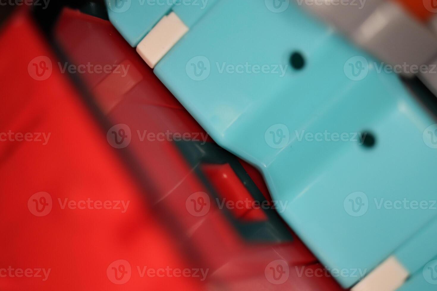 Blue and Red Transformer Toys. Assembled Plastic Construction Background. Macro Closeup. photo