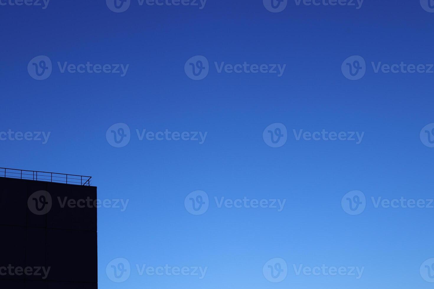 Black House Silhouette Corner on Blue Night Sky Background photo