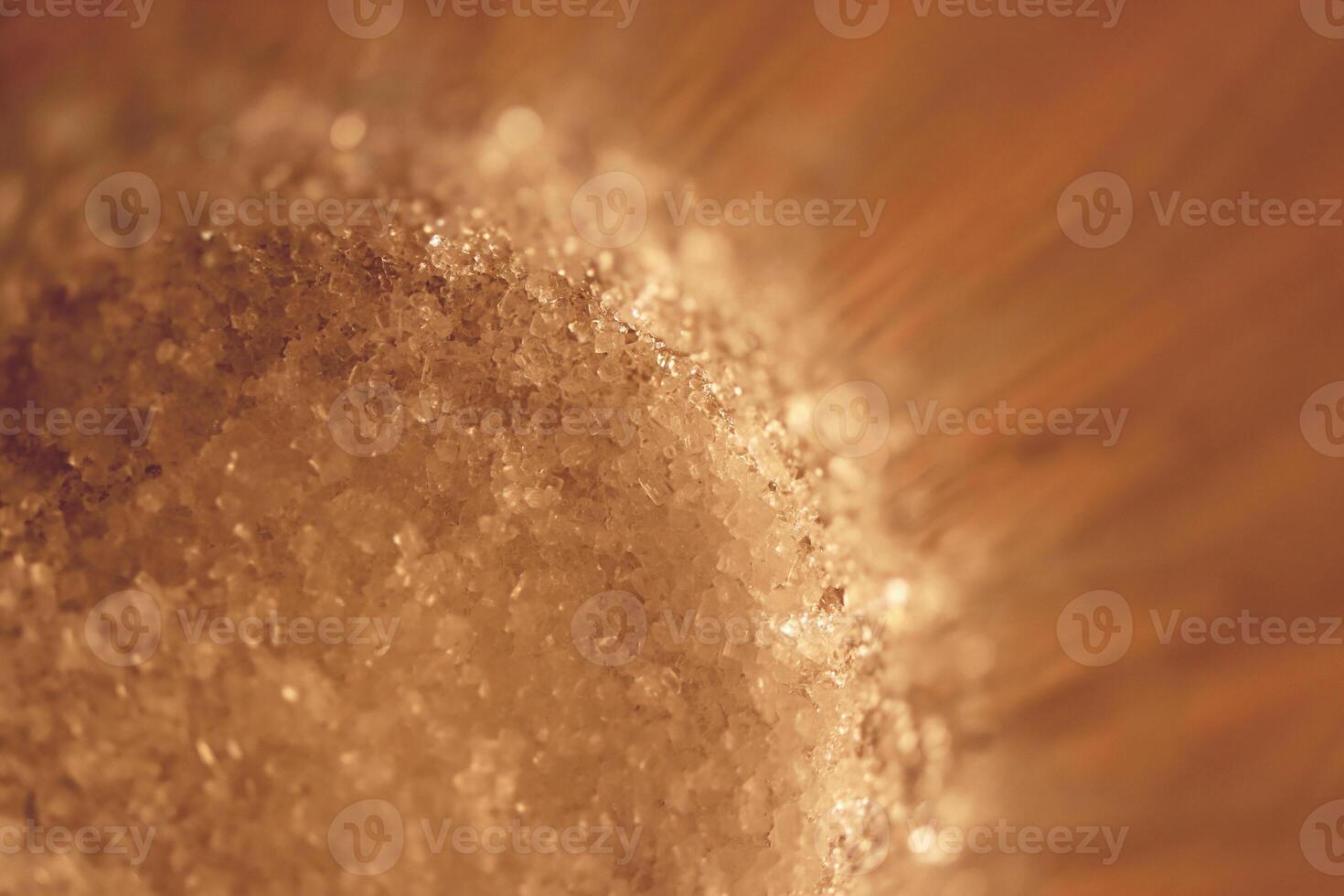 Sugar at the bottom of a faceted glass. Macro closeup artwork. photo