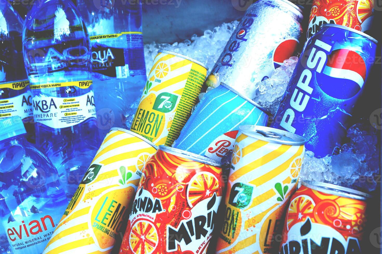 Fresh soda juice drinks in cans and bottles in ice. photo