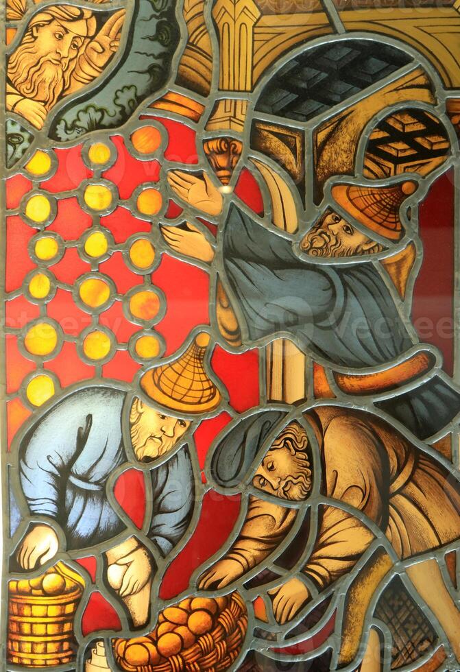 Men ask the Lord for good, pass and store. Stained glass window made of a multitude of different colored pieces of glass. photo