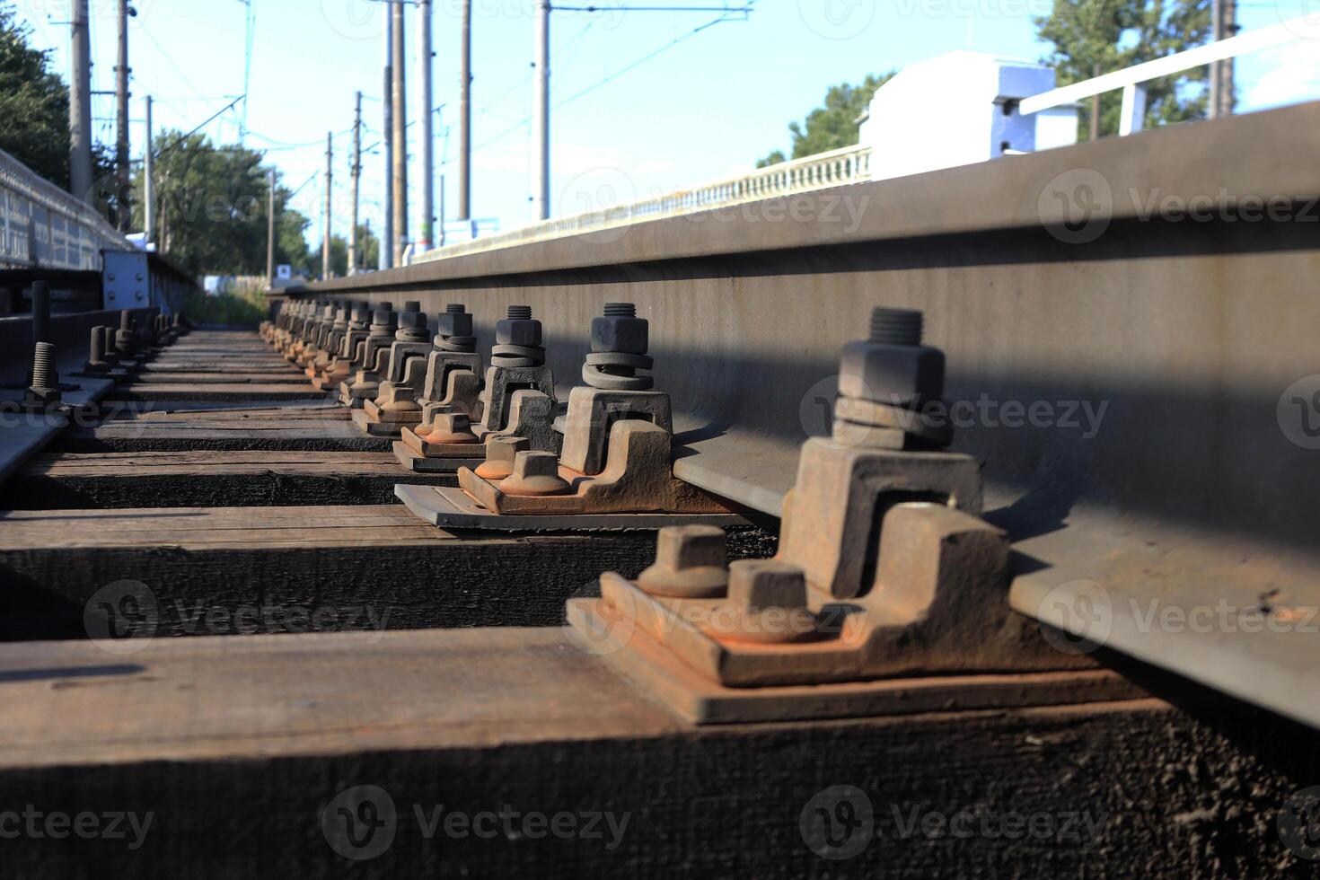 Bolts and lining the connection rails with tie leaving into the distance. photo