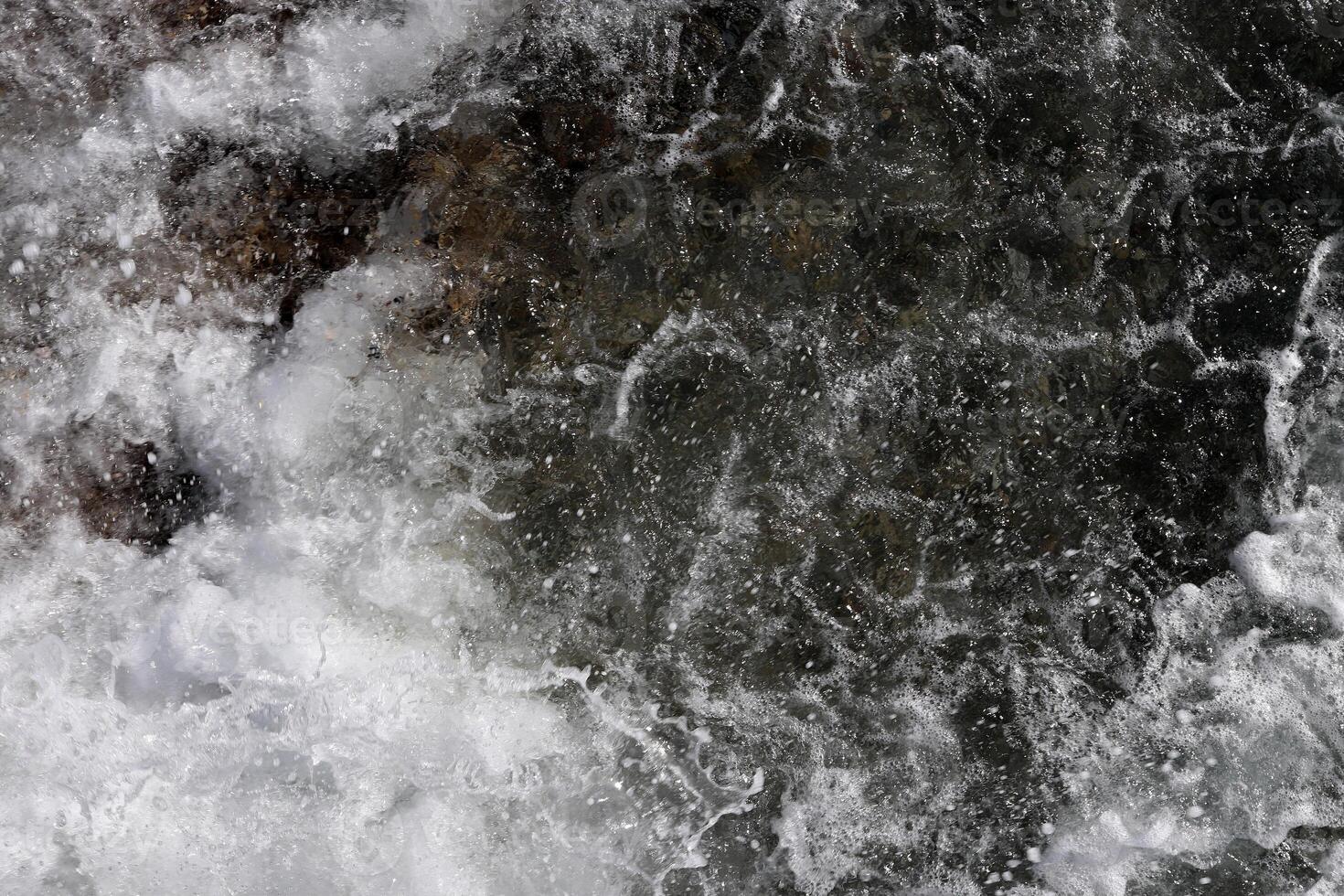 Outdoor water froth swirls backdrop. Sea wave foam texture. Marine aqua motion surface background. photo