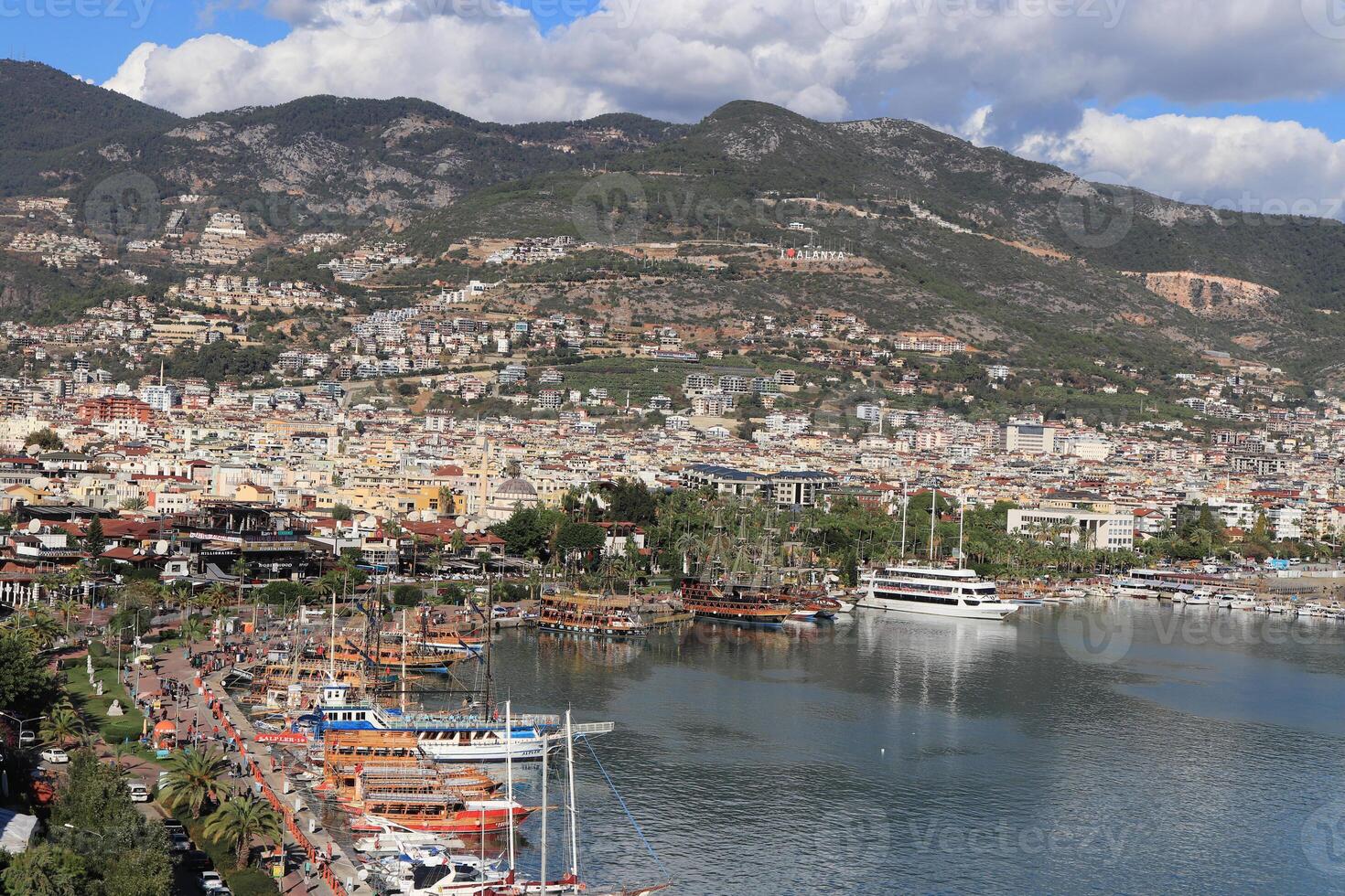 Many ships and boats in the port city. Alanya Bedesten marina bay. photo