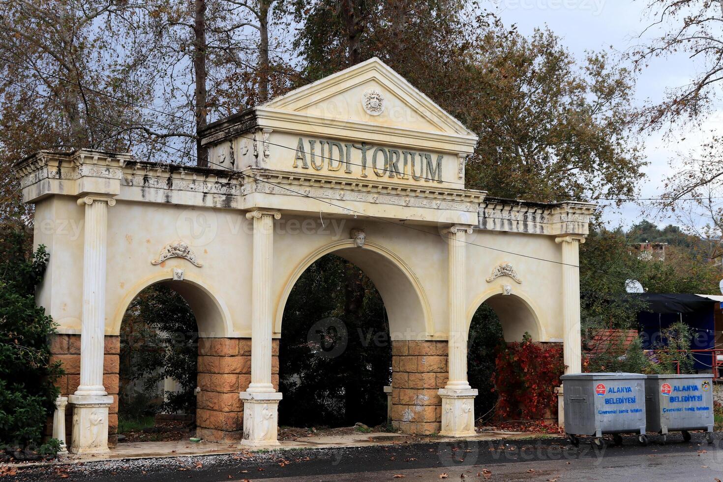 Monument to the park entrance with three arches and the inscription Auditorium photo