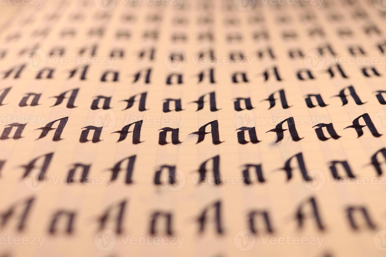 Calligraphic letter A learning skills paper page. Calligraphy letters A background. Lettering practice writing worksheet. Handwriting symbol filling pattern. photo