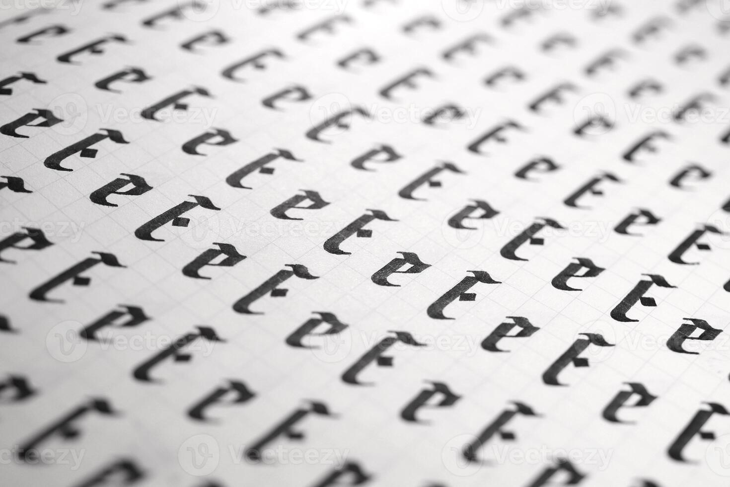 Handwriting black and white symbol filling pattern. Calligraphic letter E learning skills paper page. Calligraphy letters E background. Lettering practice writing worksheet. photo
