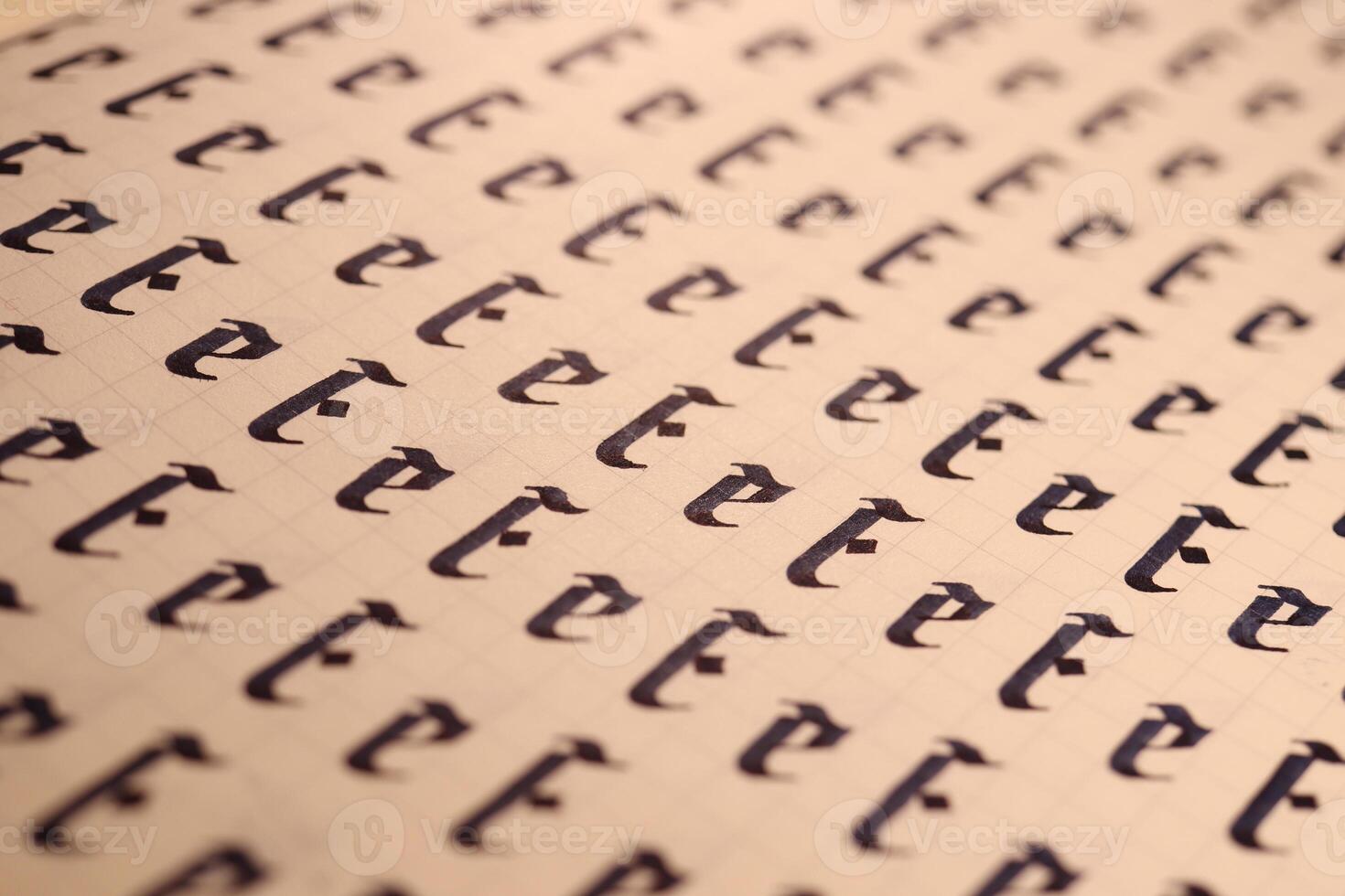 Handwriting symbol filling pattern. Calligraphic letter E learning skills paper page. Calligraphy letters E background. Lettering practice writing worksheet. photo