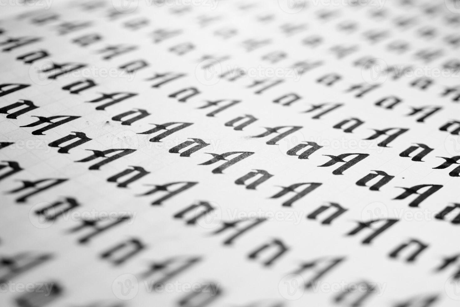 Handwriting black and white symbol filling pattern. Calligraphic letter A learning skills paper page. Calligraphy letters A background. Lettering practice writing worksheet. photo