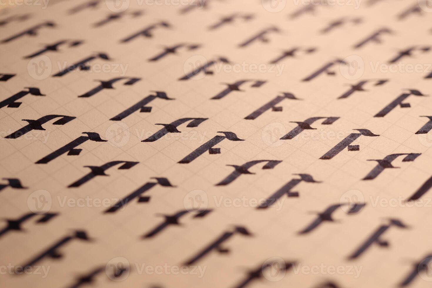 Lettering practice writing worksheet. Handwriting symbol filling pattern. Calligraphic letter F learning skills paper page. Calligraphy letters F background. photo