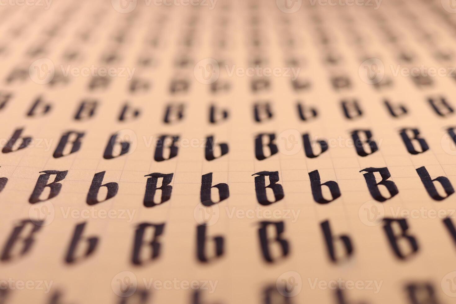 Calligraphic letter B learning skills paper page. Calligraphy letters B background. Lettering practice writing worksheet. Handwriting symbol filling pattern. photo