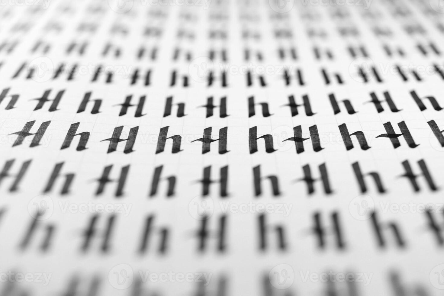 Calligraphy black and white letters H background. Lettering practice writing worksheet. Handwriting symbol filling pattern. Calligraphic letter H learning skills paper page. photo