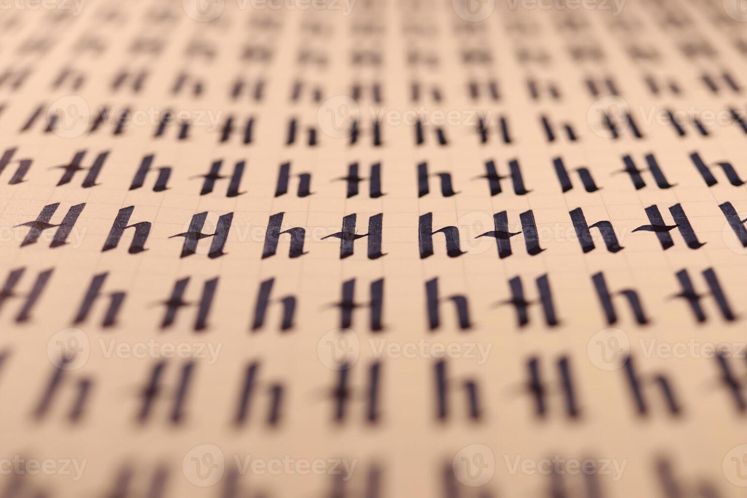 Calligraphic letter H learning skills paper page. Calligraphy letters H background. Lettering practice writing worksheet. Handwriting symbol filling pattern. photo