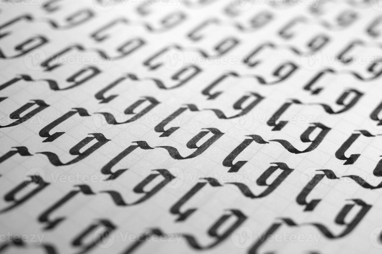 Handwriting black and white symbol filling pattern. Calligraphic letter G learning skills paper page. Calligraphy letters G background. Lettering practice writing worksheet. photo