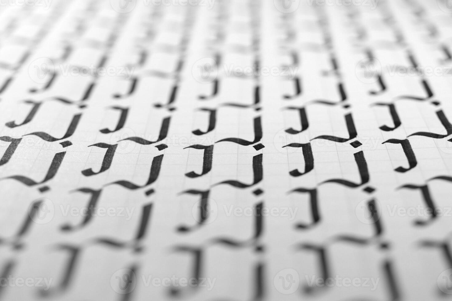 Handwriting black and white symbol filling pattern. Calligraphic letter J learning skills paper page. Calligraphy letters j background. Lettering practice writing worksheet. photo