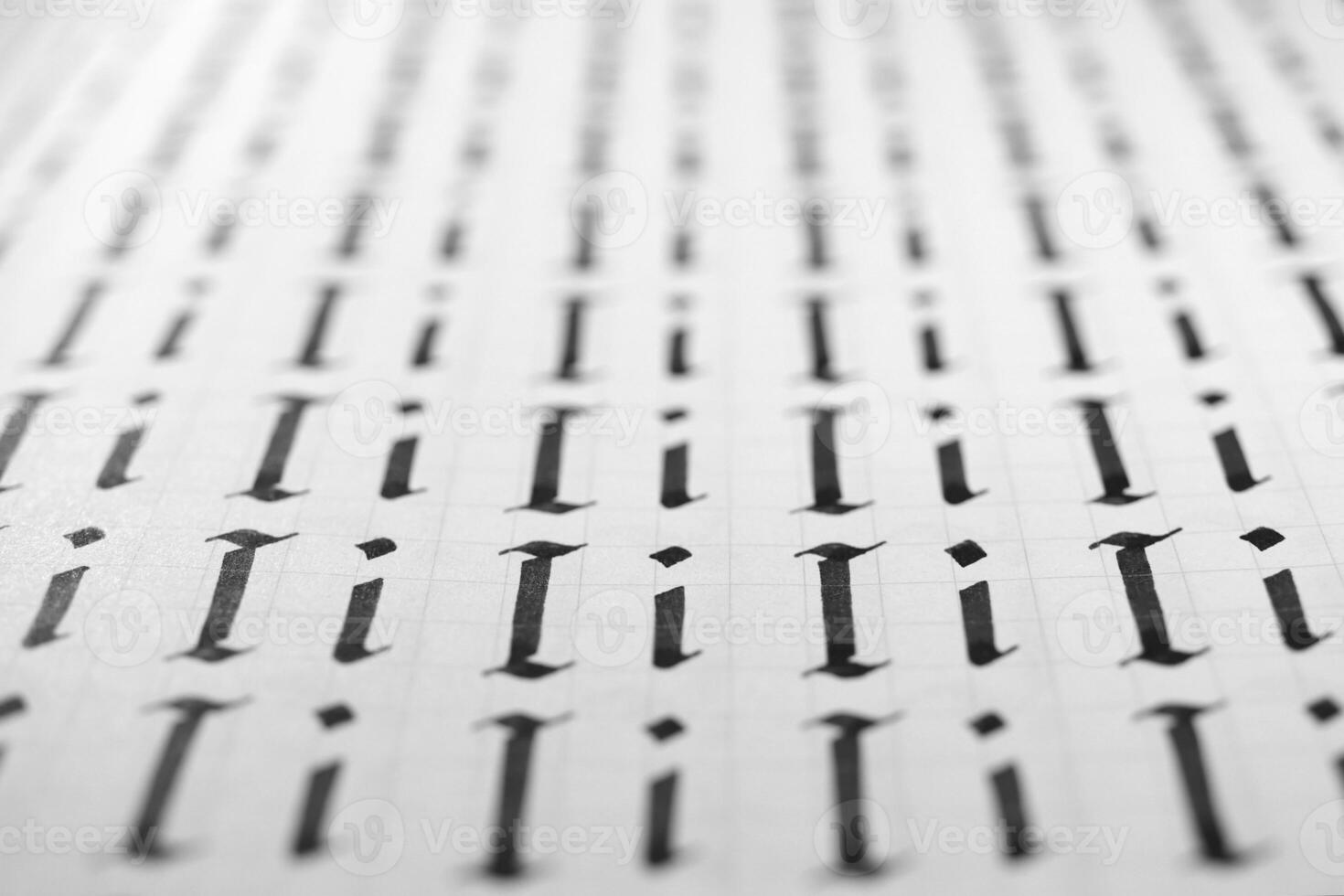 Handwriting black and white symbol filling pattern. Calligraphic letter I learning skills paper page. Calligraphy letters I background. Lettering practice writing worksheet. photo