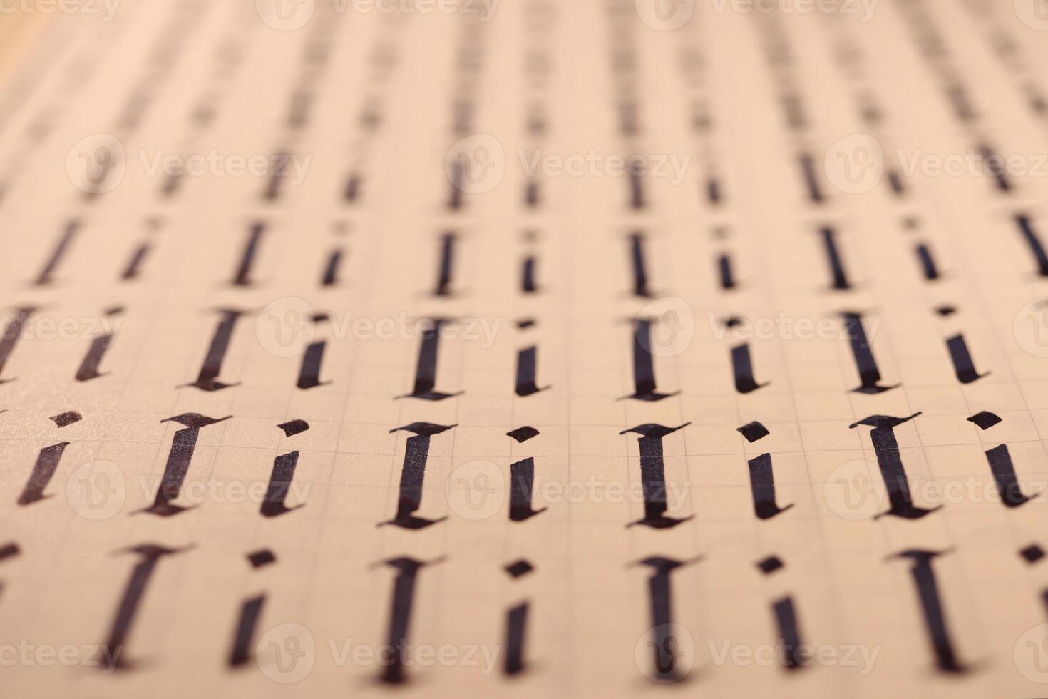 Lettering practice writing worksheet. Handwriting symbol filling pattern. Calligraphic letter I learning skills paper page. Calligraphy letters i background. photo