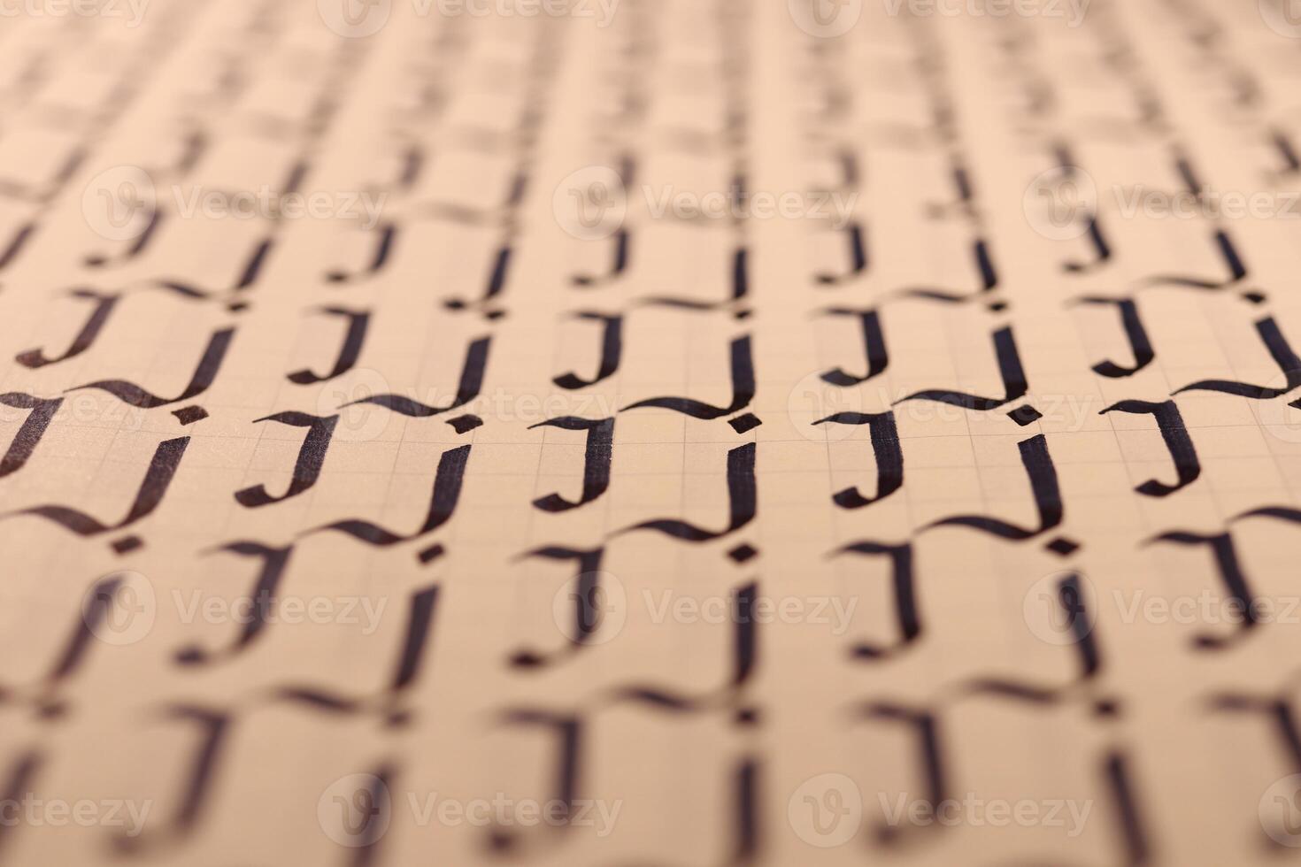 Lettering practice writing worksheet. Handwriting symbol filling pattern. Calligraphic letter J learning skills paper page. Calligraphy letters j background. photo