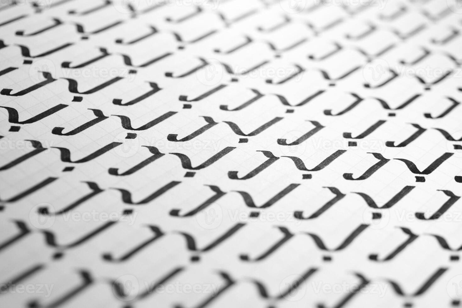 Calligraphy black and white letters J background. Lettering practice writing worksheet. Handwriting symbol filling pattern. Calligraphic letter j learning skills paper page. photo