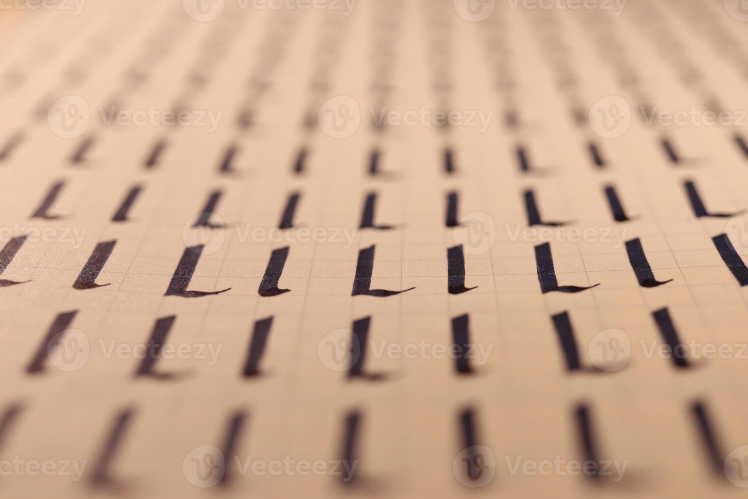 Lettering practice writing worksheet. Handwriting symbol filling pattern. Calligraphic letter L learning skills paper page. Calligraphy letters l background. photo
