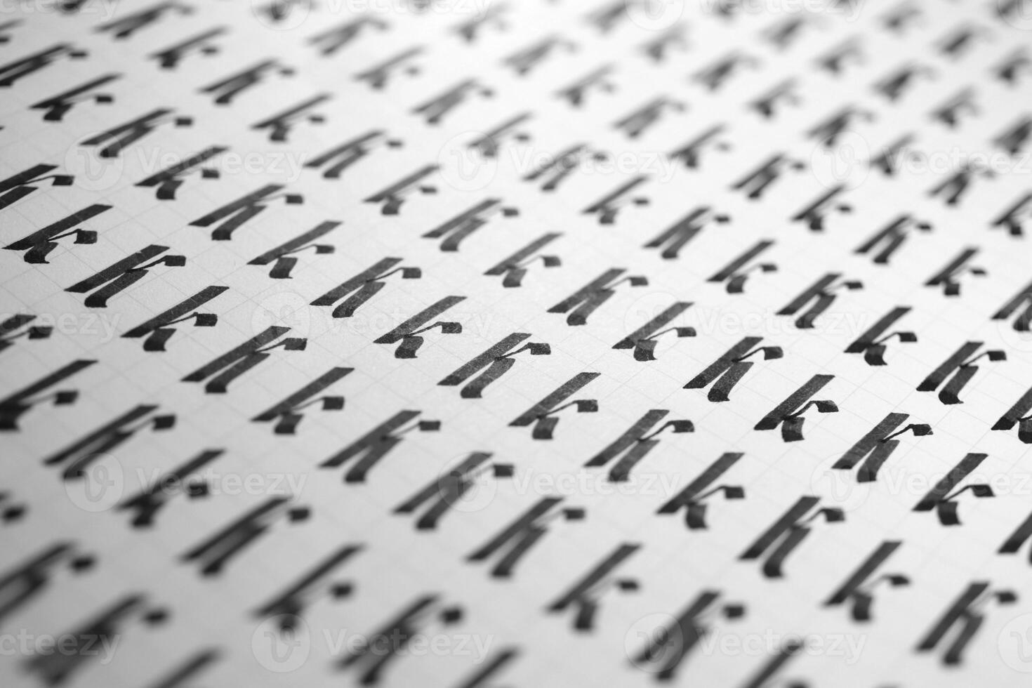 Calligraphy black and white letters K background. Lettering practice writing worksheet. Handwriting symbol filling pattern. Calligraphic letter K learning skills paper page. photo