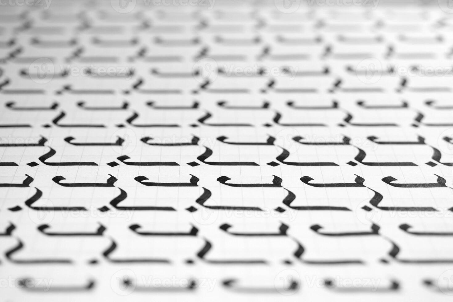 Handwriting black and white symbol filling pattern. Calligraphic letter J learning skills paper page. Calligraphy letters j background. Lettering practice writing worksheet. photo