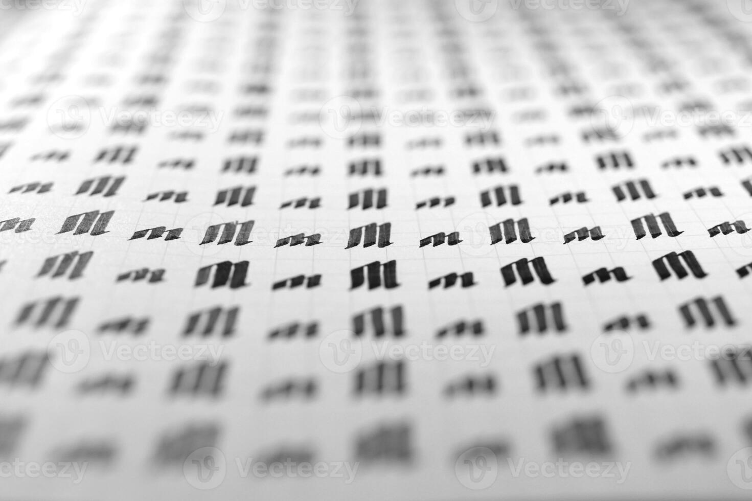 Handwriting black and white symbol filling pattern. Calligraphic letter M learning skills paper page. Calligraphy letters m background. Lettering practice writing worksheet. photo