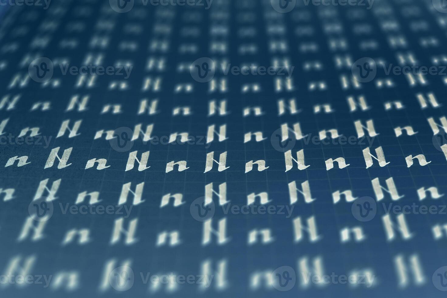 Lettering white on dark blue practice writing worksheet. Handwriting symbol filling pattern. Calligraphic letter N learning skills paper page. Calligraphy letters n background. photo