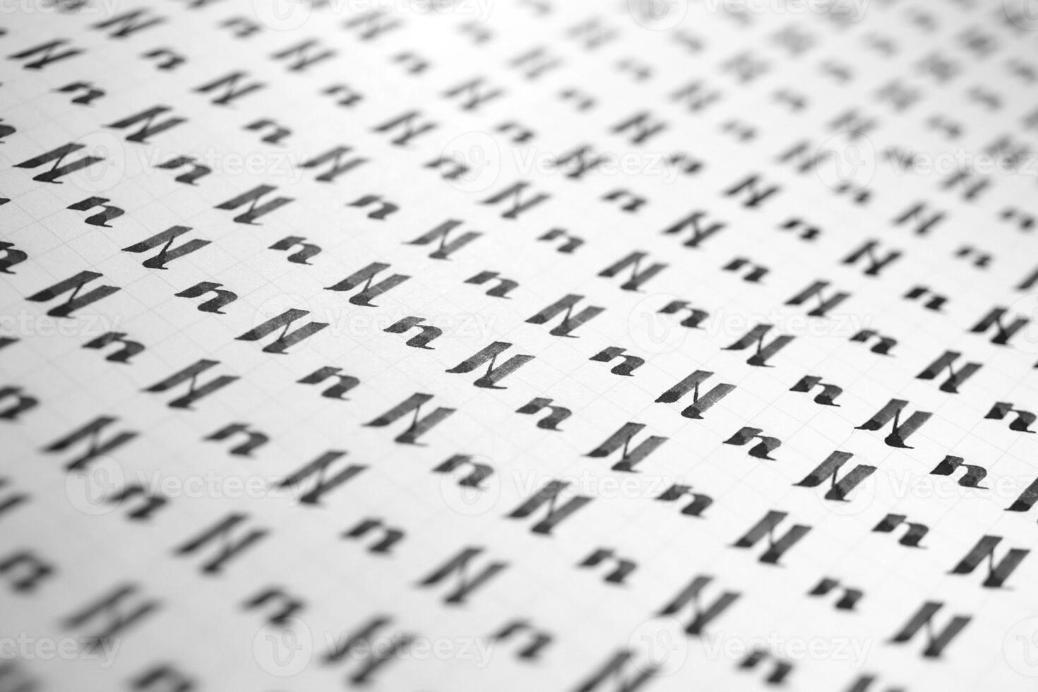 Calligraphy black and white letters N background. Lettering practice writing worksheet. Handwriting symbol filling pattern. Calligraphic letter n learning skills paper page. photo