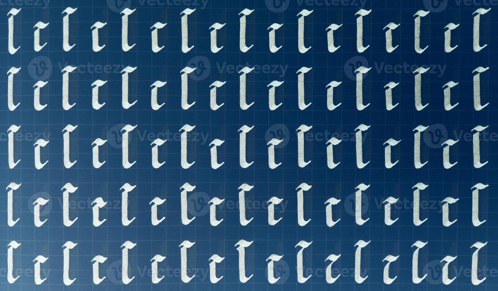 Calligraphic white on dark blue letter C learning skills paper page. Calligraphy letters c background. Lettering practice writing worksheet. Handwriting symbol filling pattern. photo