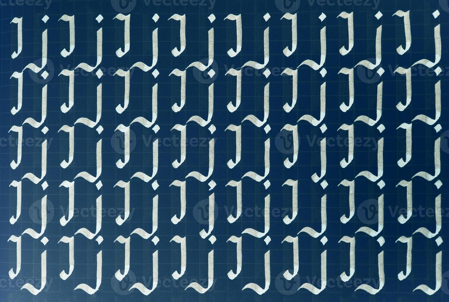Lettering white on dark blue practice writing worksheet. Handwriting symbol filling pattern. Calligraphic letter J learning skills paper page. Calligraphy letters j background. photo