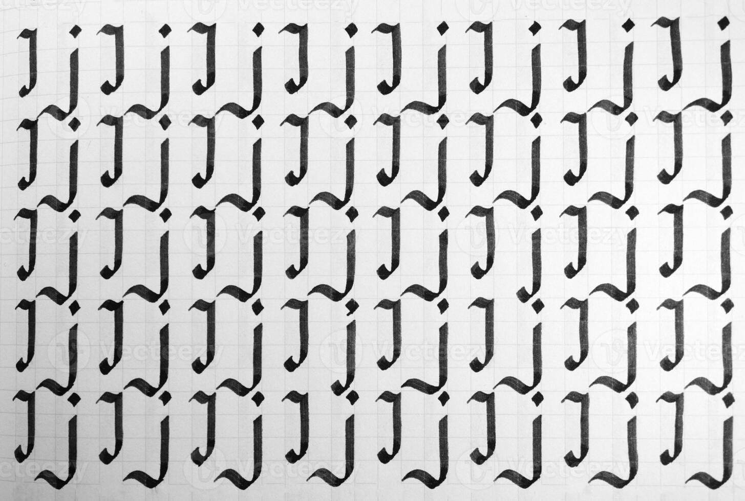 Handwriting black and white symbol filling pattern. Calligraphic letter J learning skills paper page. Calligraphy letters j background. Lettering practice writing worksheet. photo