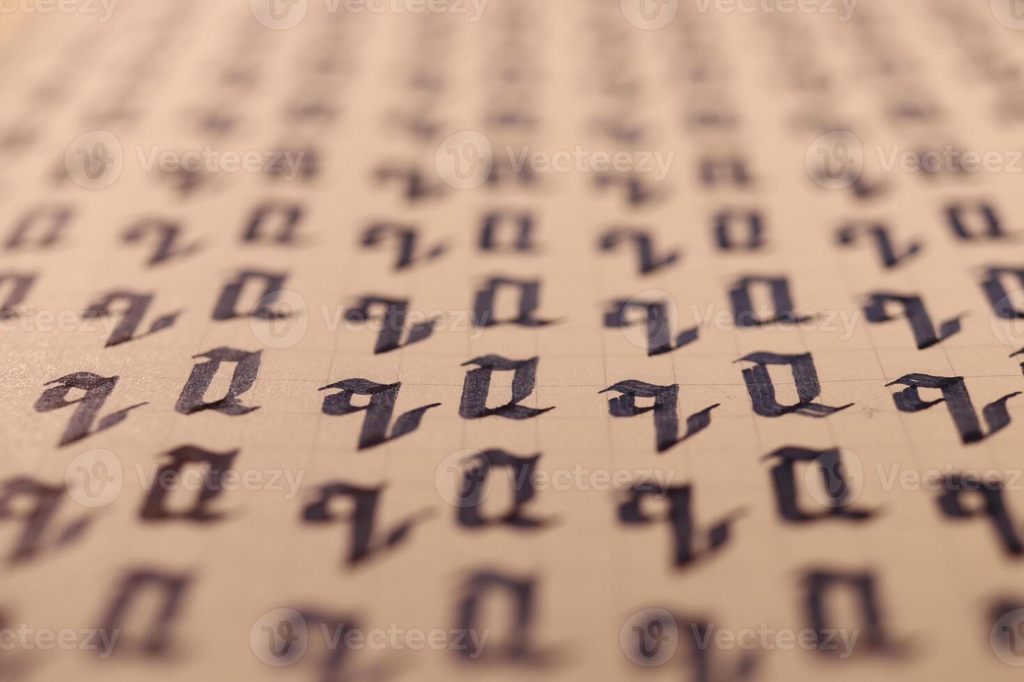 Lettering practice writing worksheet. Handwriting symbol filling pattern. Calligraphic letter Q learning skills paper page. Calligraphy letters q background. photo