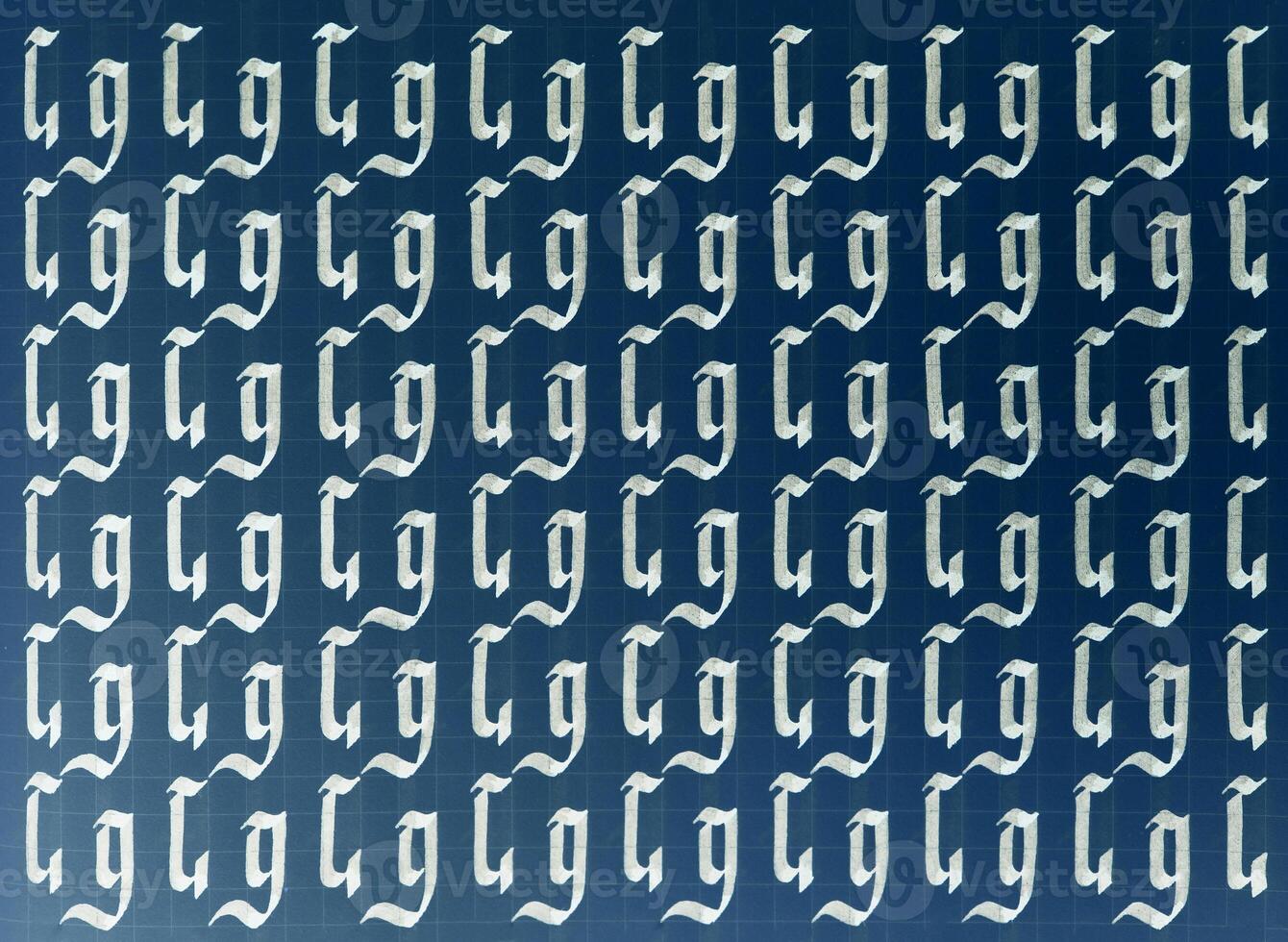 Calligraphic white on dark blue letter G learning skills paper page. Calligraphy letters g background. Lettering practice writing worksheet. Handwriting symbol filling pattern. photo