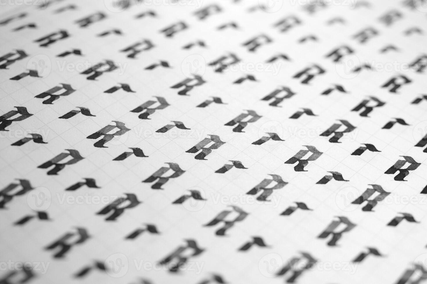 Handwriting black and white symbol filling pattern. Calligraphic letter R learning skills paper page. Calligraphy letters r background. Lettering practice writing worksheet. photo