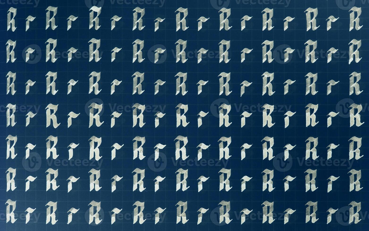 Calligraphic white on dark blue letter R learning skills paper page. Calligraphy letters r background. Lettering practice writing worksheet. Handwriting symbol filling pattern. photo